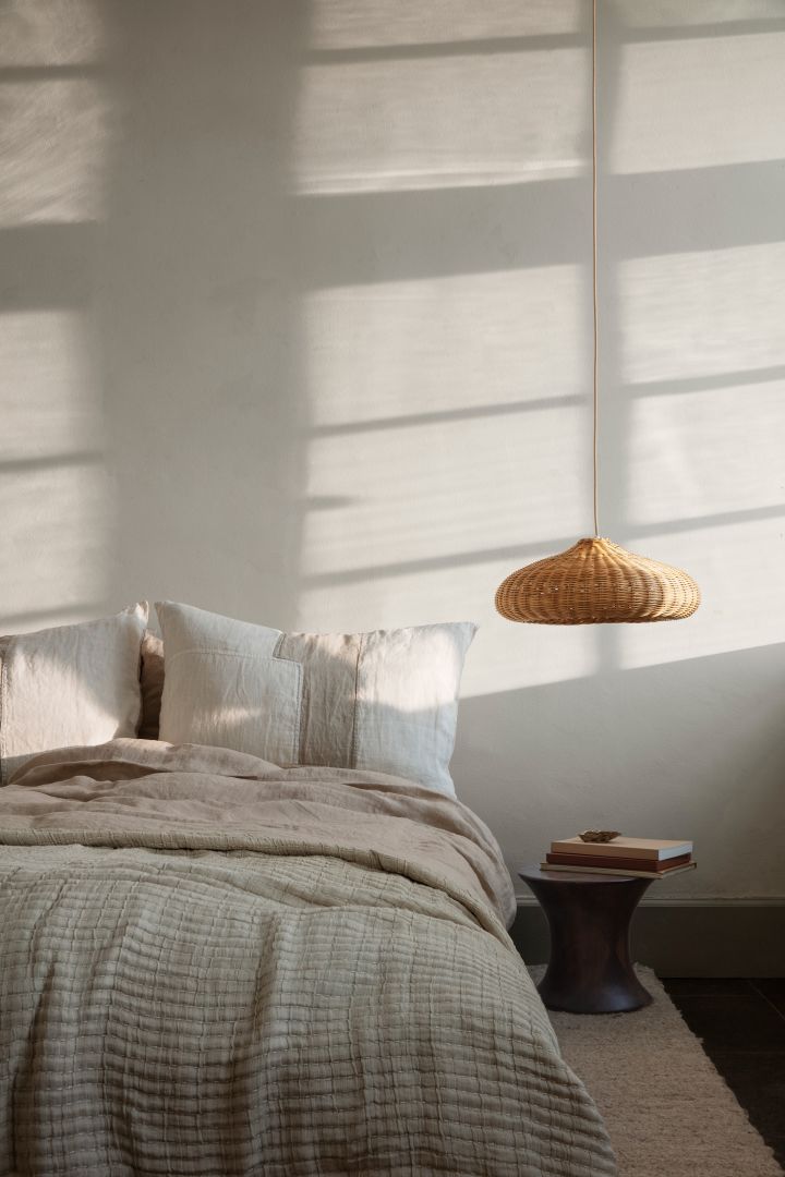 A cozy bedroom with soft pillows and lovely bedspread from Ferm Living.