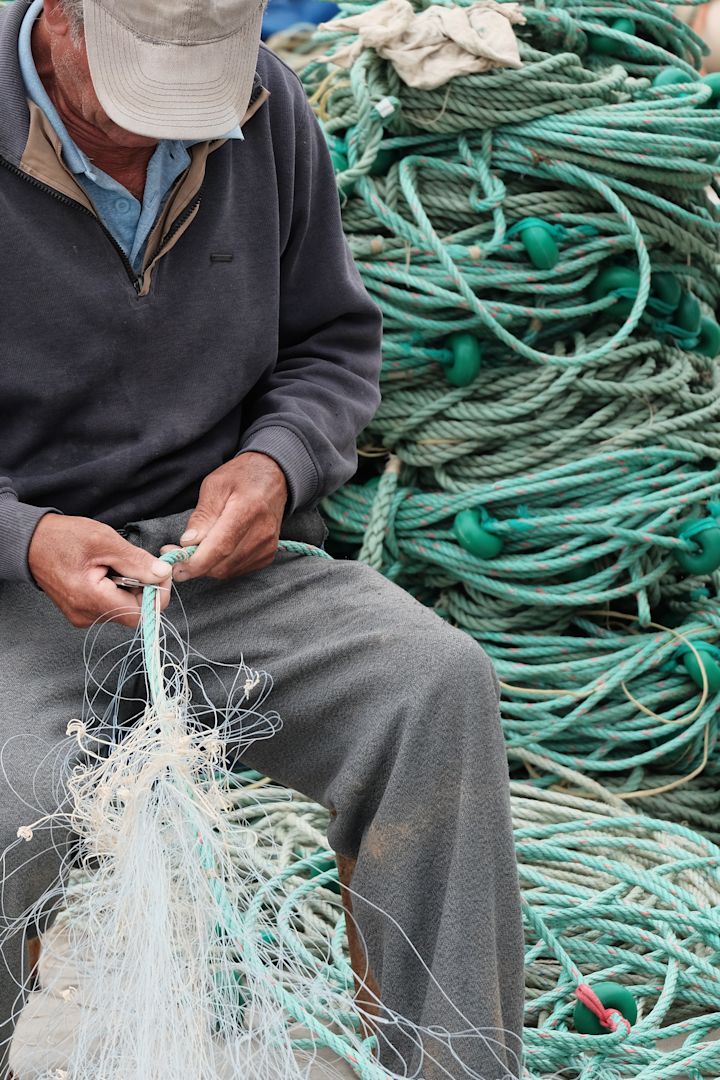 Here you see a man cleaning fishing nets in Portugal, part of the sustainable furniture initiative from Ekbacken studios where the nets will be turned into 3D printed furniture. 