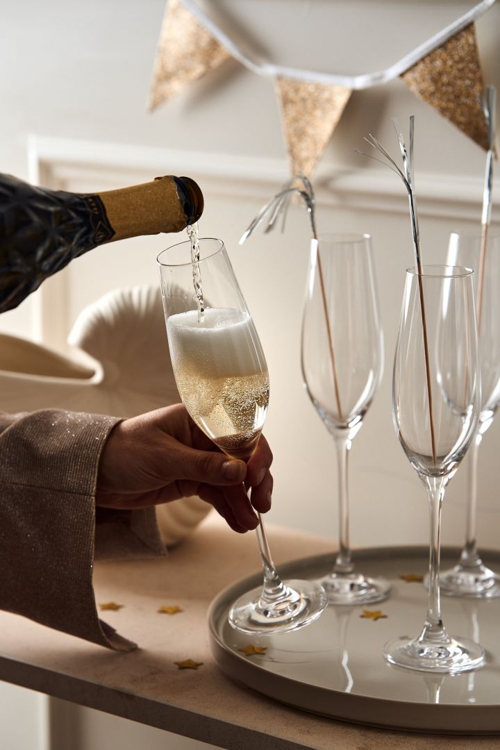 New year party ideas - here you see someone pouring champagne into the karlevi champagne glasses from Scandi Living. 