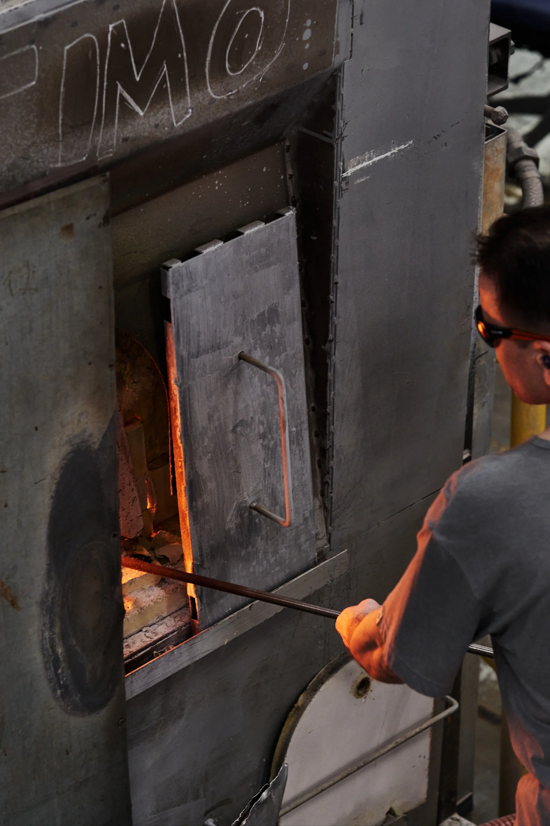 A man puts glass into the furnace at the Iittala's glassworks in Finland. 
