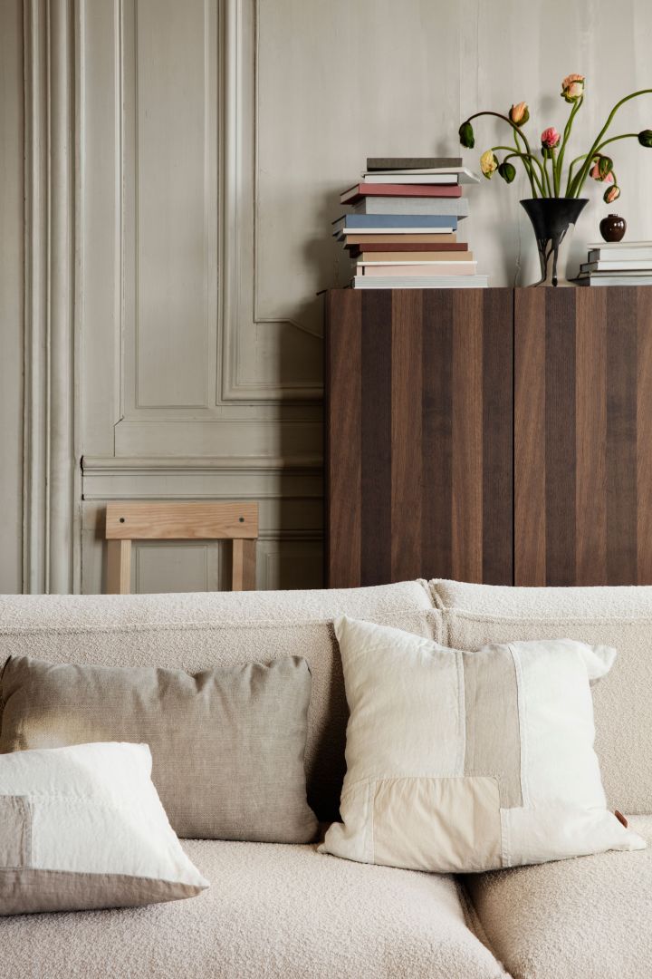 A cozy livingroom with pillows, sofa and details from Ferm Living.