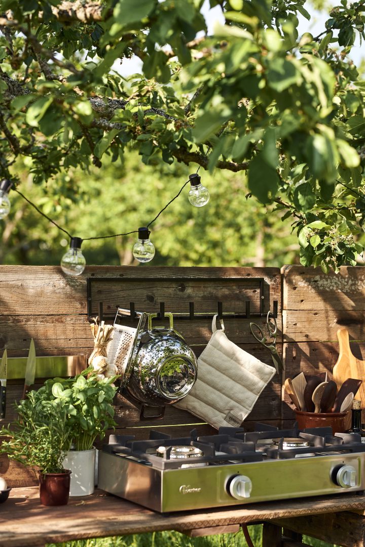 The back wall of your DIY outdoor kitchen is perfect for hanging utensils that you need to have easily available.