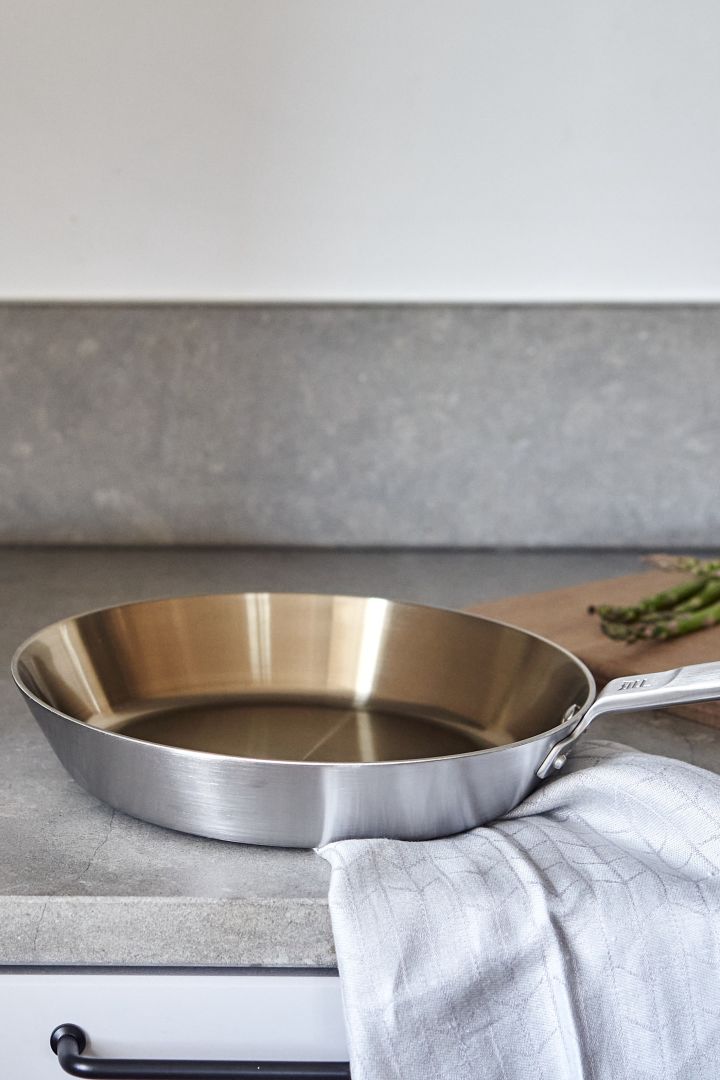 Renew your kitchen with 11 practical and stylish kitchen accessories for easier cooking - here you see a durable Nordic stainless steel frying pan from Fiskars.