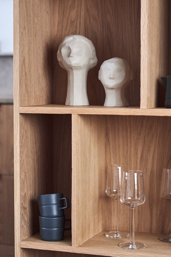 These limestone sculptures from Cooee Design are perfect for the autumn interior design trends 2021. Here they sit in a wooden bookshelf together with black Line mugs from NJRD.