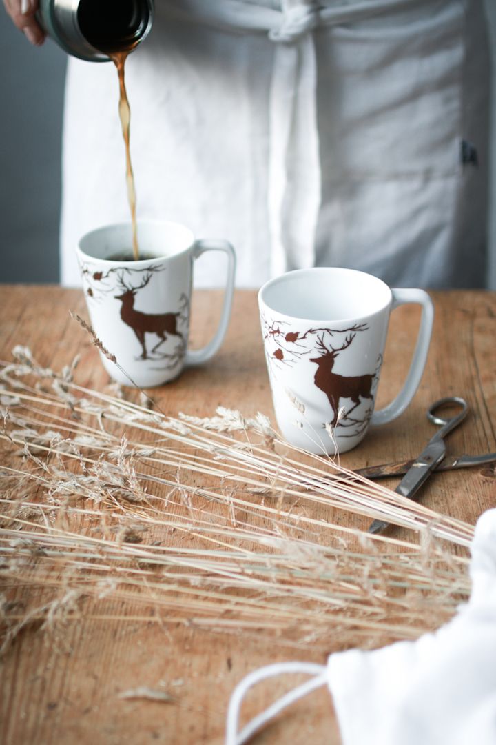 Someone pours coffee into the Alveskog mug from Wik & Walsøe.