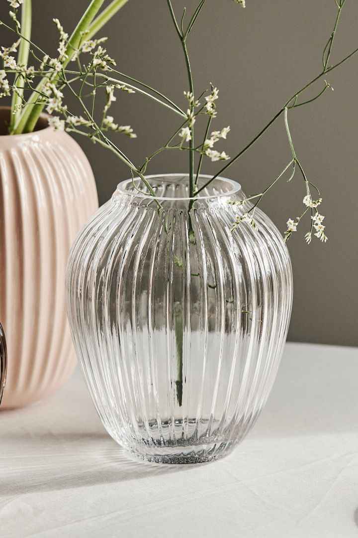 The medium clear glass vase in the Hammershøi collection for Kähler looks perfect on the dining table. 