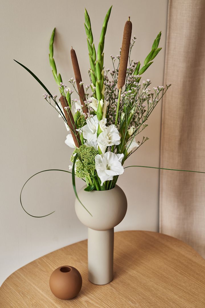 The stylish and popular Pillar vase in shell from Cooee Design is a large vase that looks perfect on the dining table. 