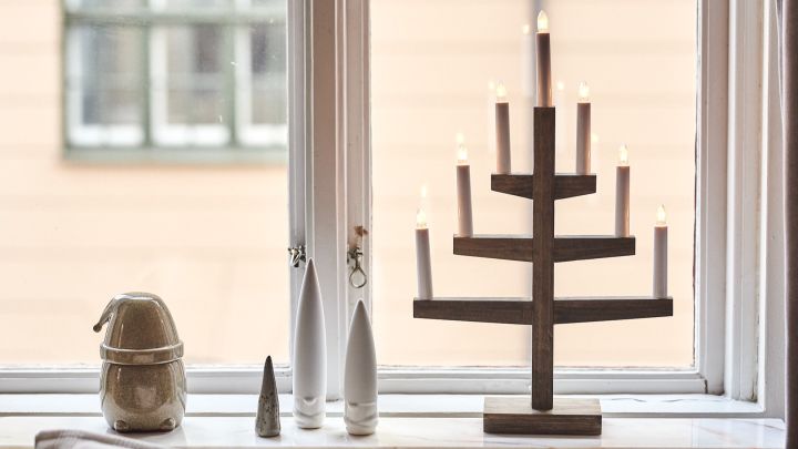 Modern and minimalist Christmas decor with the Trapp candlestick in brown stain and ceramic Christmas elves.