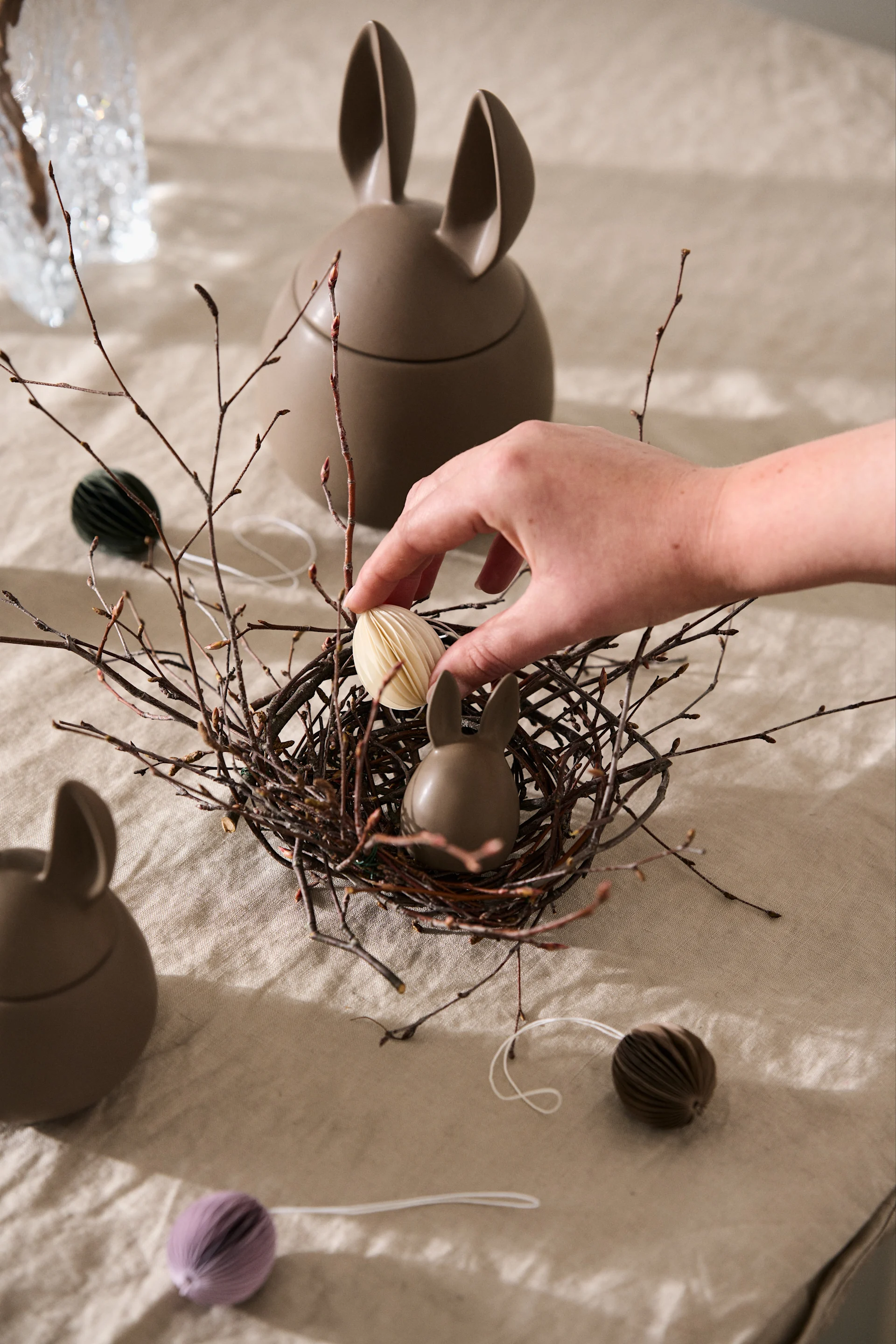 A cute bird's nest made from bark twigs and wire is easy to make for Easter and makes a pretty Easter decoration for the Easter table or windowsill.