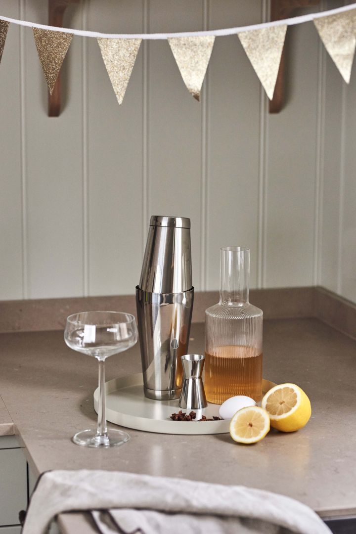 4 festive cocktail recipes for new year - Dorre shaker, Rosendahl measuring glass and Ripple carafe from Ferm Living on tray from Cooee Design.