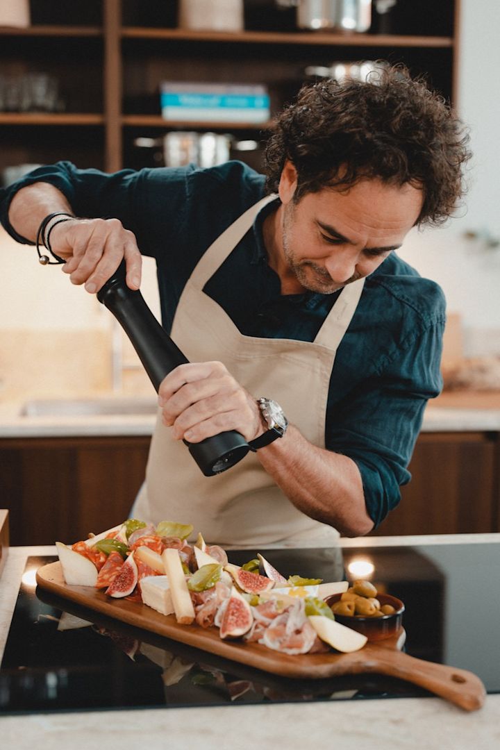 Master chef Markus Aujalay in his kitchen with cutting board and pepper mill from his own brand of kitchen and cooking products.