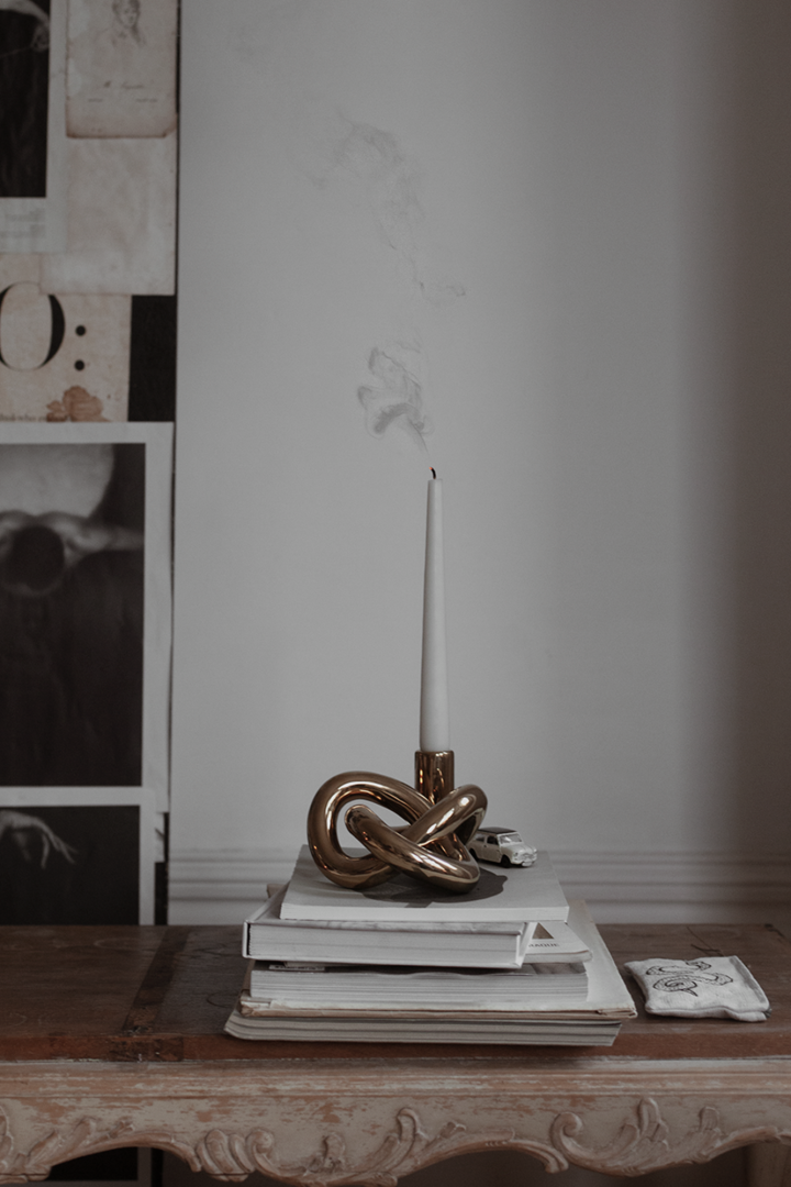 The Lykke One candle holder from By On with a blown out, grey tapered candle from Ester and Erik.
