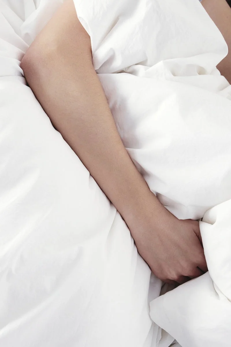 Create a hotel style bedroom with crisp white bedsheets.