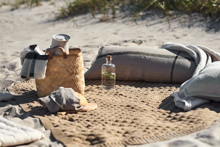 A picnic blanket with cushions for a cosy picnic a true summer essential. 