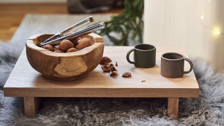 Low side table with wooden bowl and mulled wine mugs from DBKD fits perfectly into a more minimalist Christmas decor.