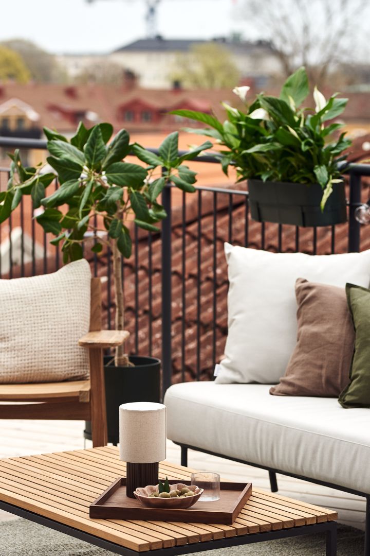 Decorate your balcony with green plants in large plant pots and hanging boxes like this one from Ferm Living. 