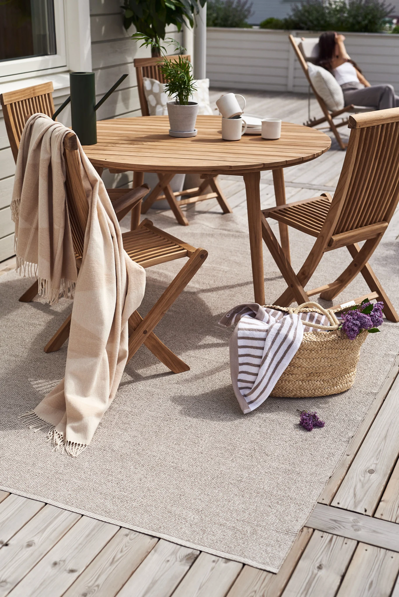 Add decorating your patio to your summer bucket list and create that oasis you have always wished for. Here you see a decked area decorated with wooden Viken chairs from Skargaarden. 