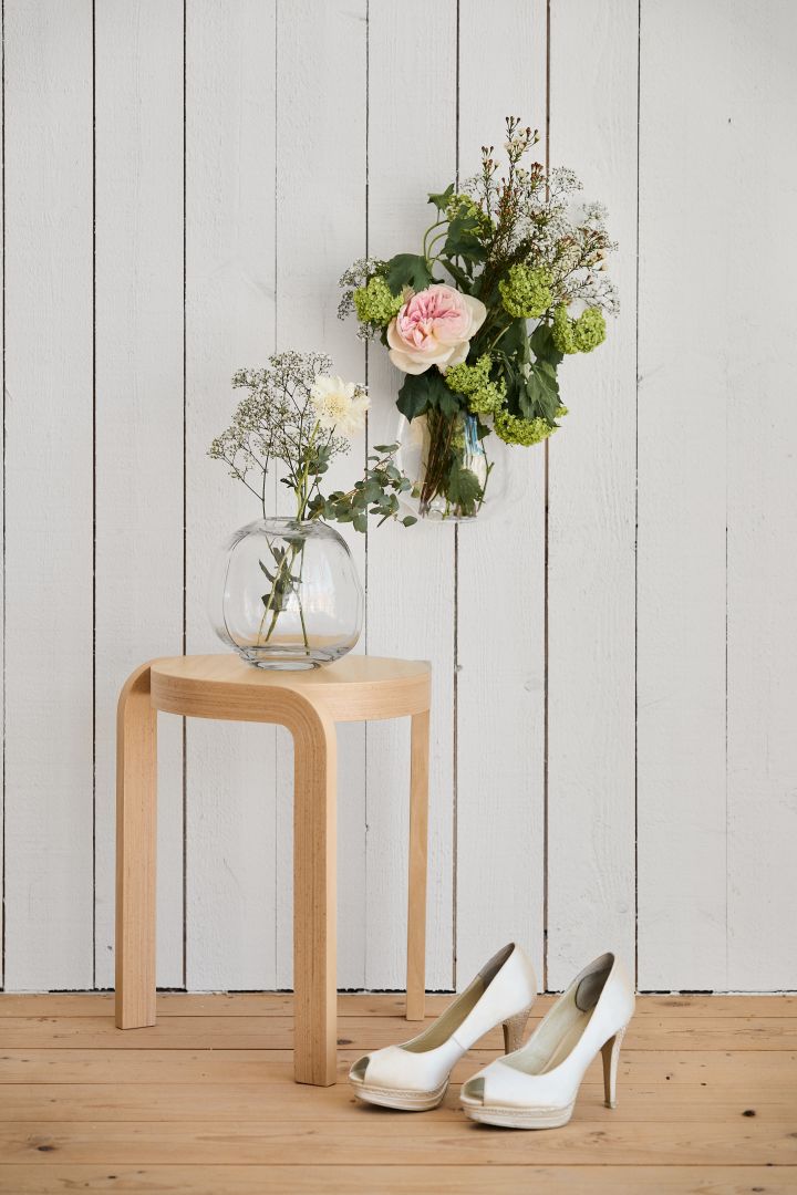 Unique wedding ideas need to be photographed to be remembered. Here you see the Swedese wooden stool and two vases hanging over a pair of wedding shoes. 
