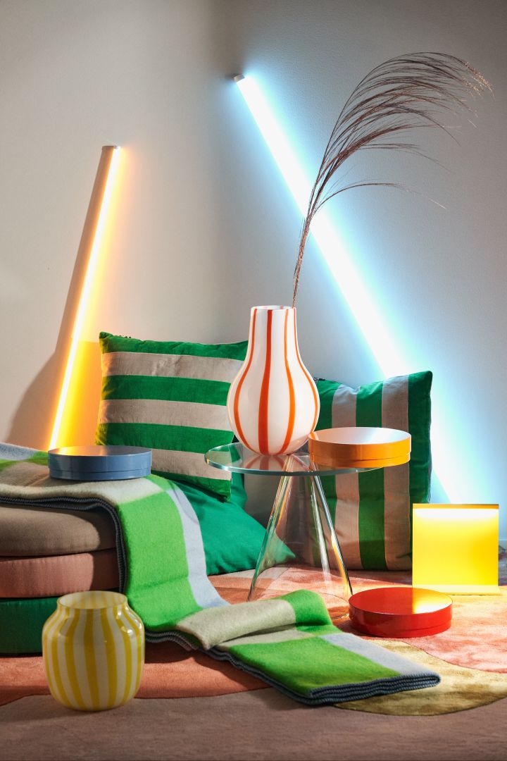 Interior colour trends 2024 are filled with neon, influenced by the virtual world. Here in vases, cushions and LED-ligths in different shades of neon.