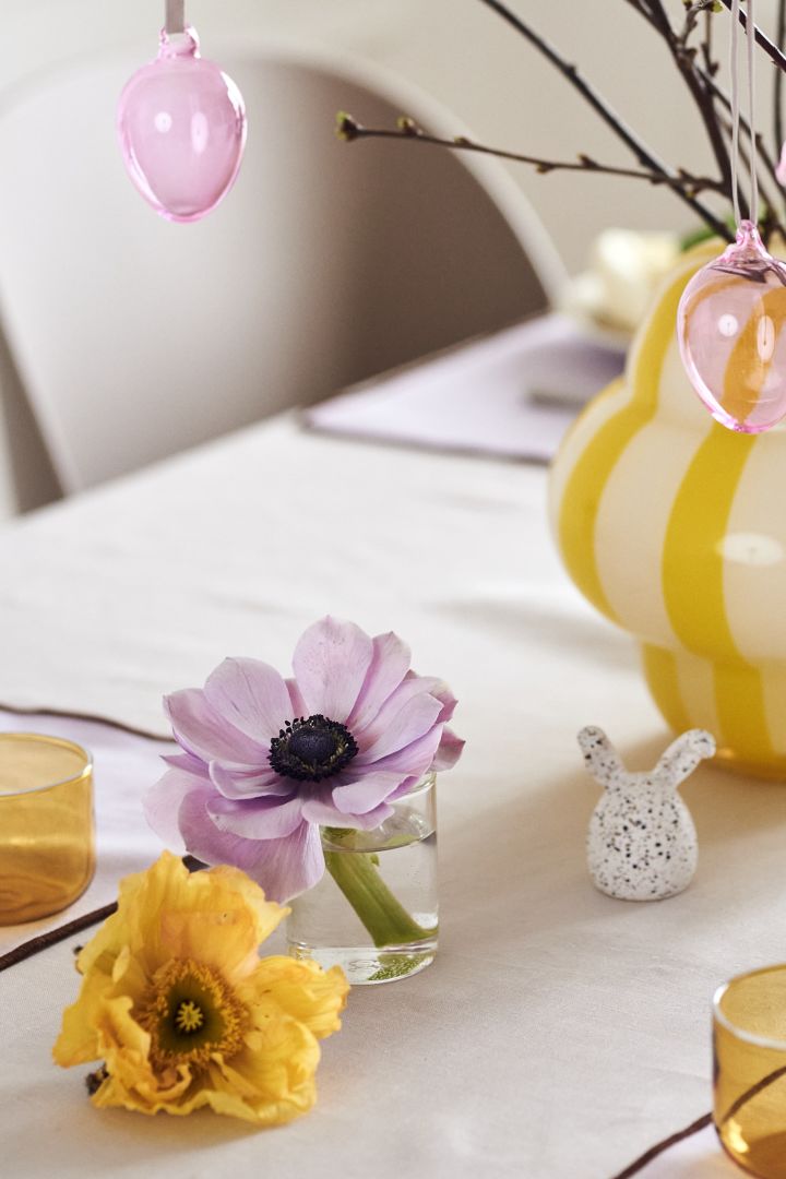 Create a festive Easter table setting in spring pastels with fine cut flowers, colourful glass eggs from Iittala and Easter bunnies from DBKD.
