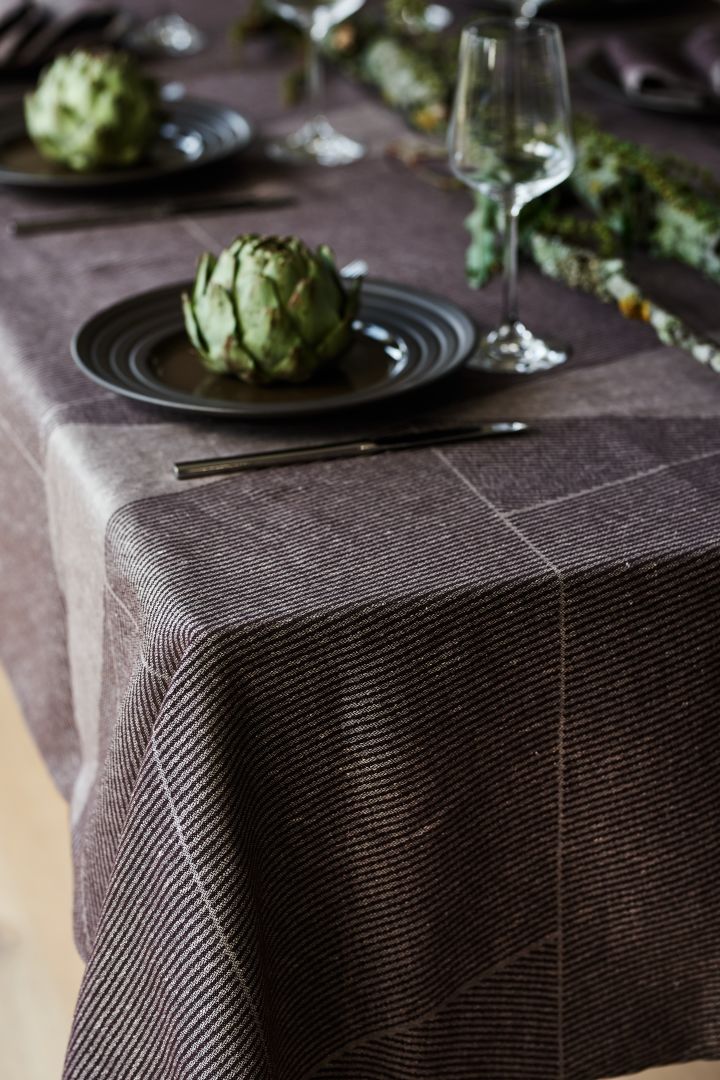 A brown table cloth from NJRD with the brown Lines plate also from NJRD on an elegant and rustic table setting.