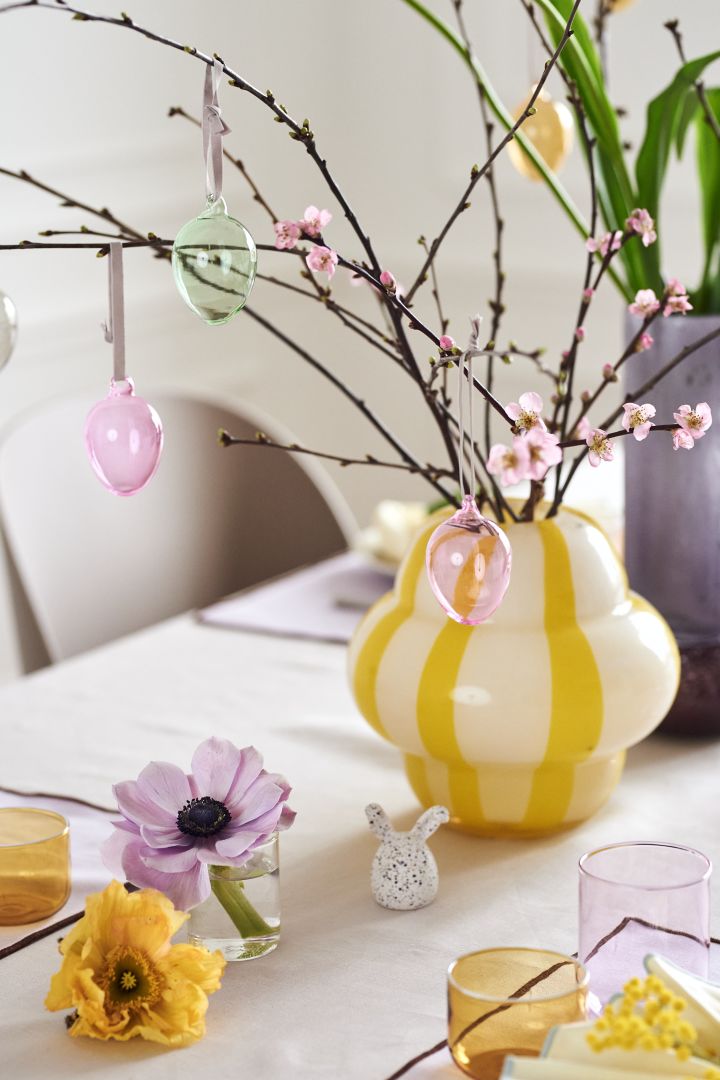 Create a festive Easter table setting in spring pastels with Iittala's colourful glass eggs in a beautiful Easter branch that is in the Curlie vase from By On.