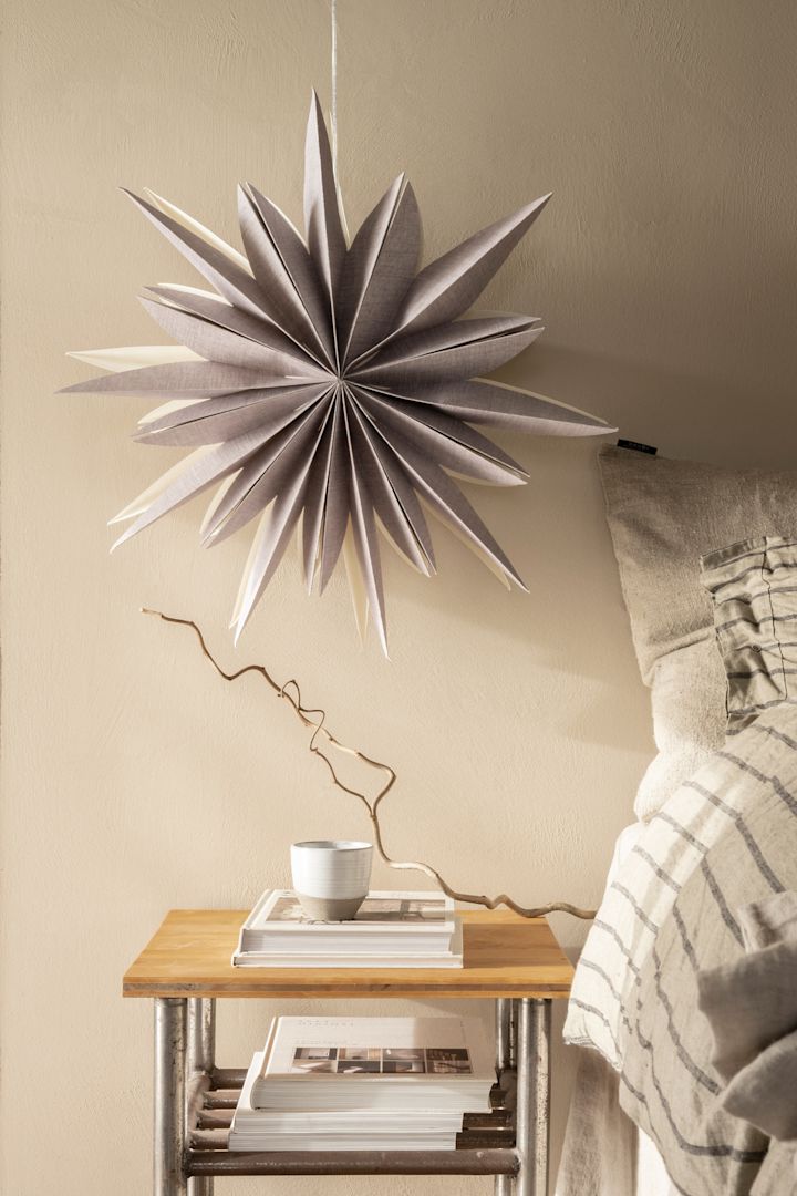 How to decorate with traditional Scandinavian Christmas decorations - Christmas stars in different shapes and materials like the Fiona folded paper star in lilac from Watt & Veke, 