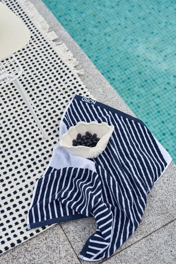 The Stripes towel from NJRD  in blue with the Shell bowl from By On make the perfect Mediterranean additions to your decor. 