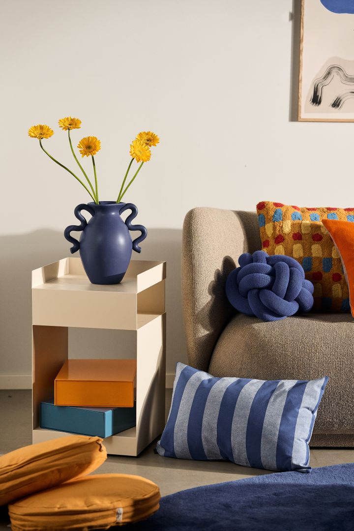 The interior colour trends for 2024 include blue hues, orange and amber - all present here in a colourful living room setting.