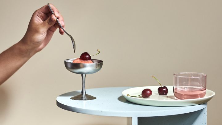 Our interiors for 2022 will include soft pastels inspired by the 80's, here the Tint drinking glass and the Italian Ice Cup dessert bowl, both from HAY, sit on top of the Teema plate from Iittala accompanied by ice cream and cherries.