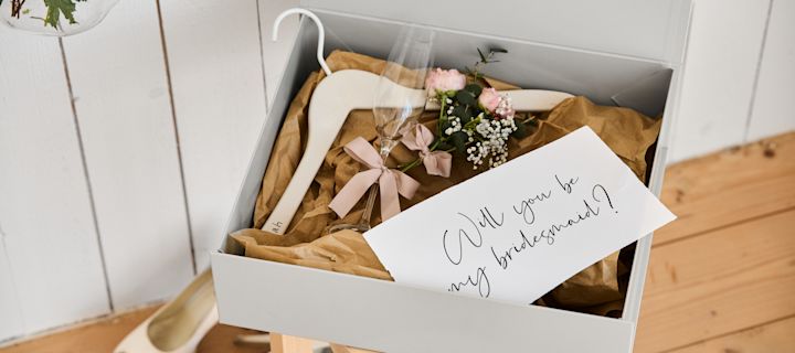 Include these unique wedding ideas in your big day like a personised bridesmaid proposal with a hanger for the dress, a champagne glass and a hand storage box. 