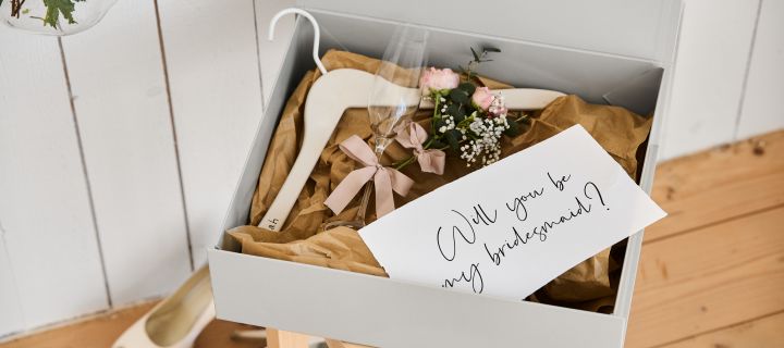 Include these unique wedding ideas in your big day like a personised bridesmaid proposal with a hanger for the dress, a champagne glass and a hand storage box. 