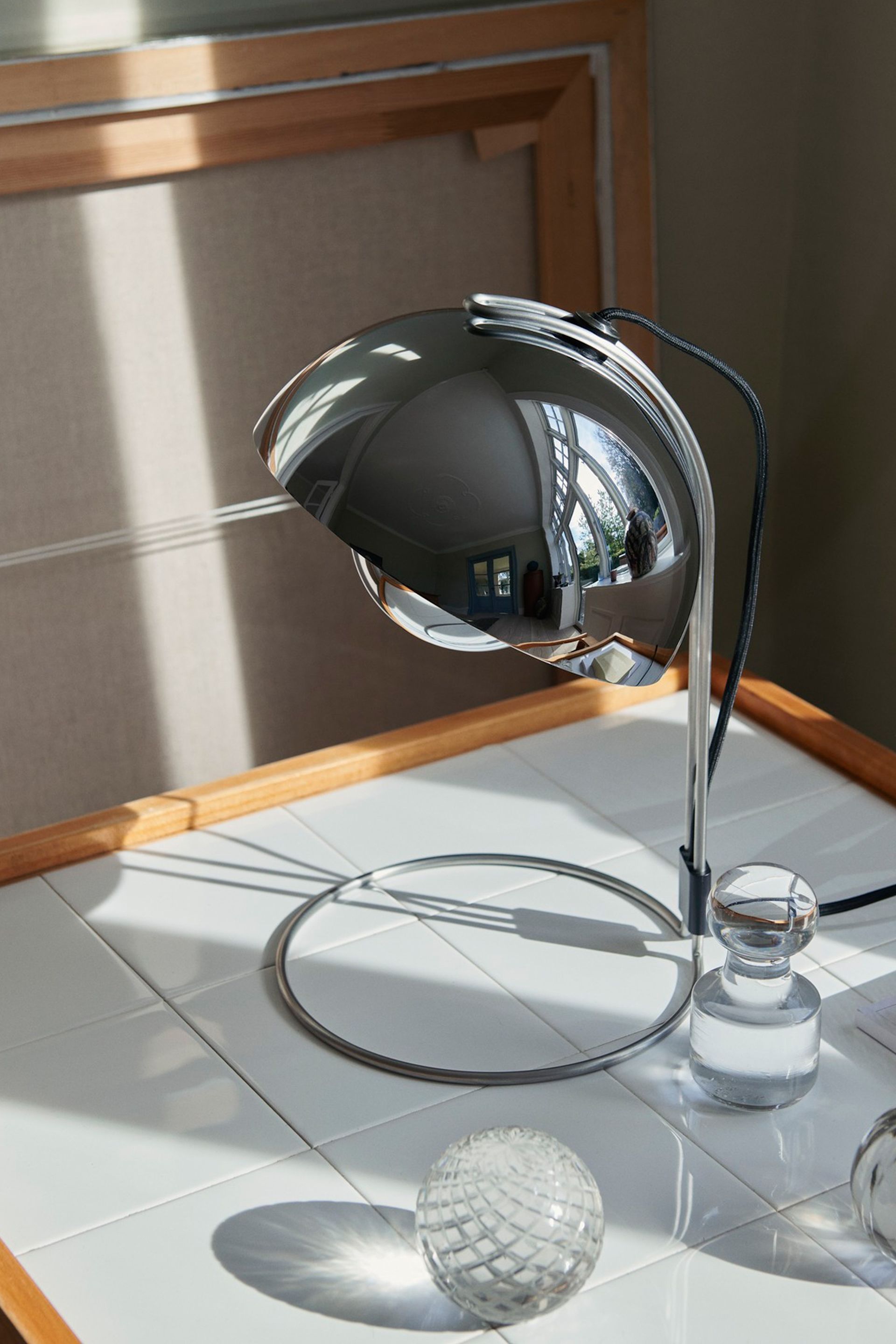 Chrome is a big part of this year's 2024 interior design trends. Here, The Flowerpot VP4 Table Lamp From & Tradition in a Chrome Finish.