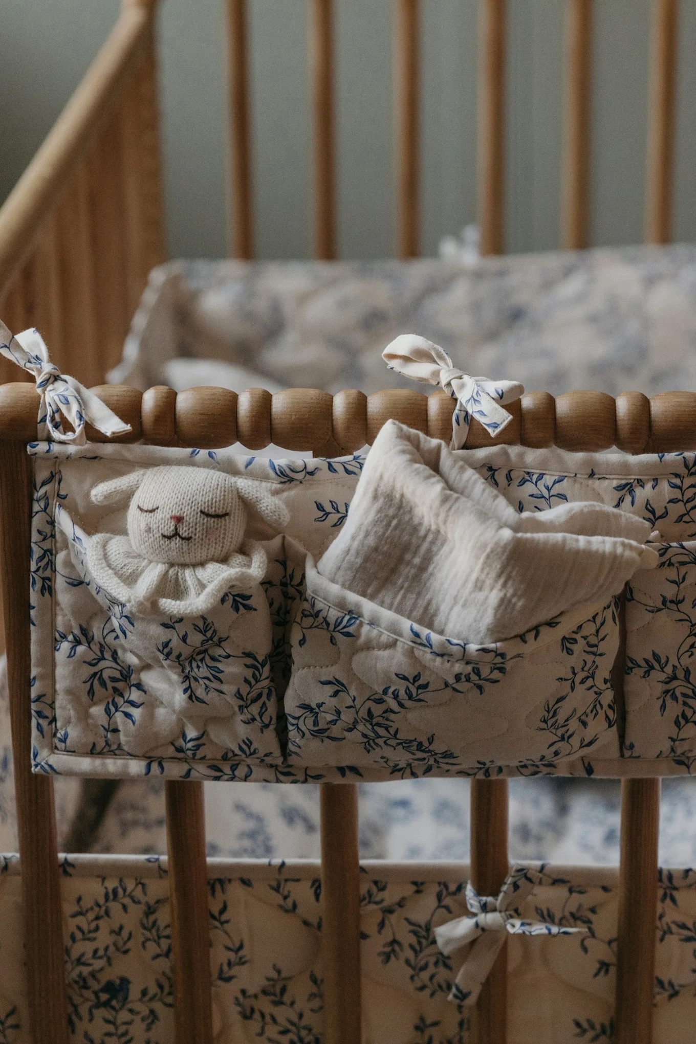 Here you see a rustic cot dressed in the Fauna Forest bed set from Garbo&Friends with a match crib pocket, the perfect baby shower gift ideas. 
