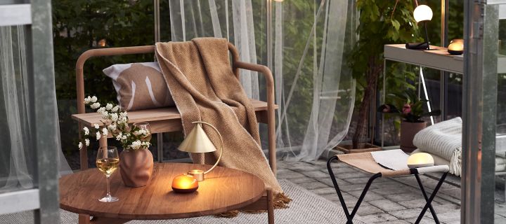 Cosy patio decor ideas - Create a cosy patio by decorating your patio with lovely textiles, cosy lighting and inviting green plants to create an oasis.