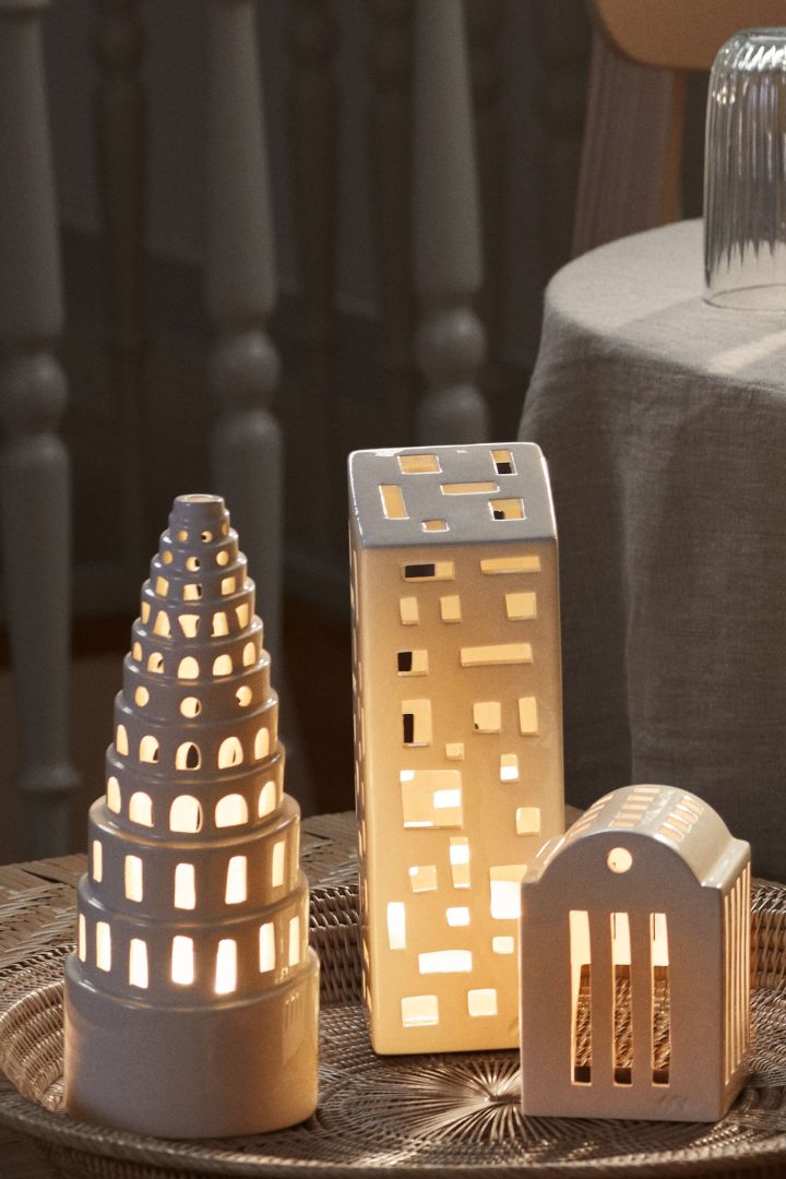 Christmas decorations 2023 are nostalgic and cosy, preferably in the form of cute decorative houses to create Christmas scenes with - this Urbania candle house from Kähler.