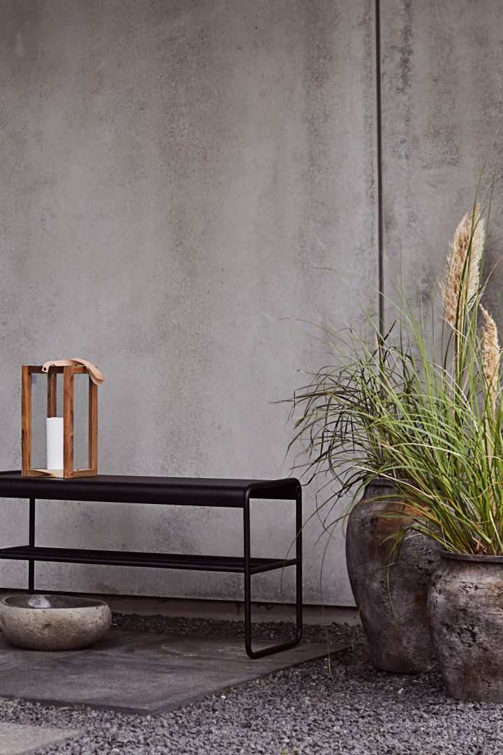 The rustic Hanja outdoor plant pot from Muubs stands in a pair on a patio. 