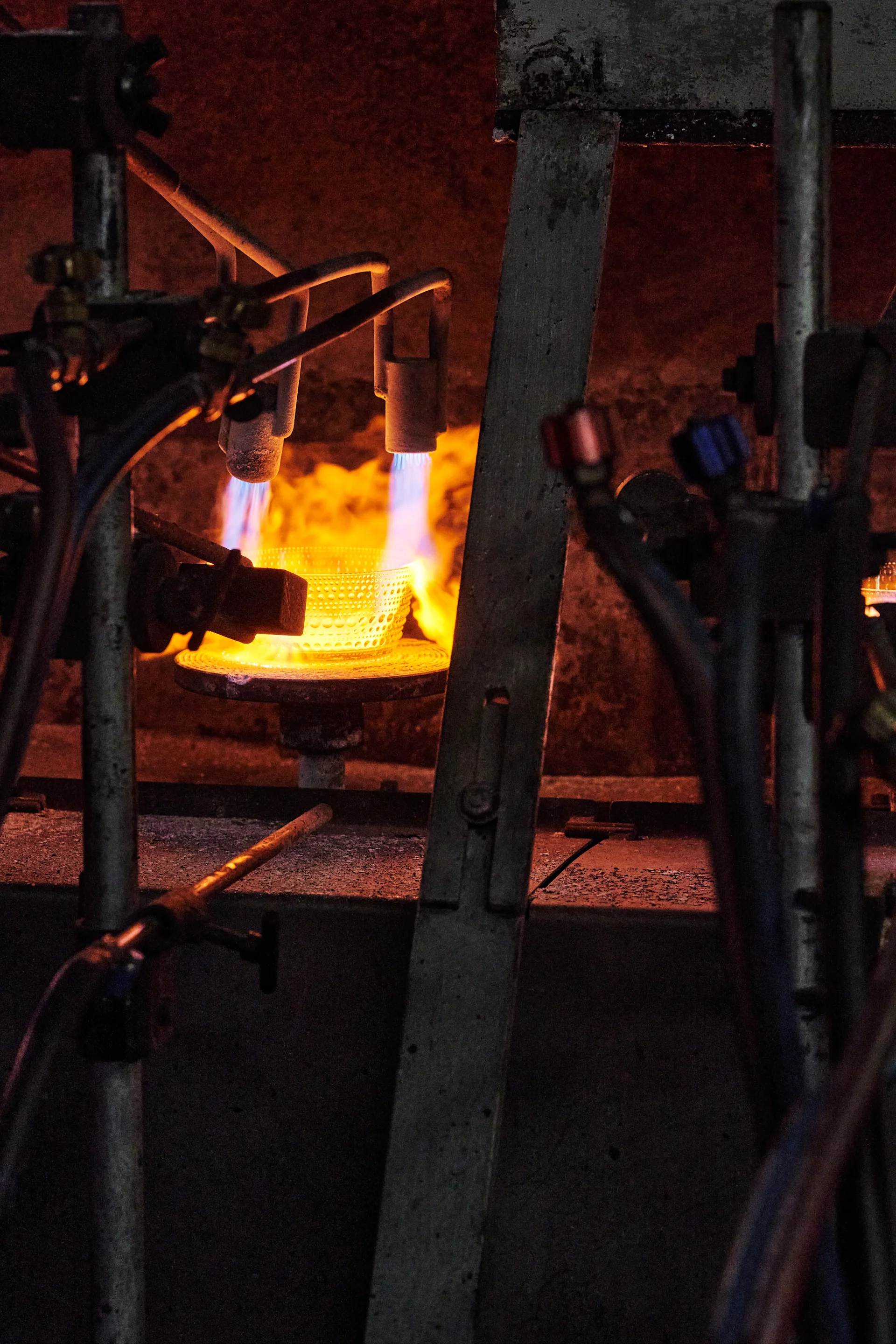 A Kastehemi bowl is heated in a furnace at Iittala's glassworks in Finland. 