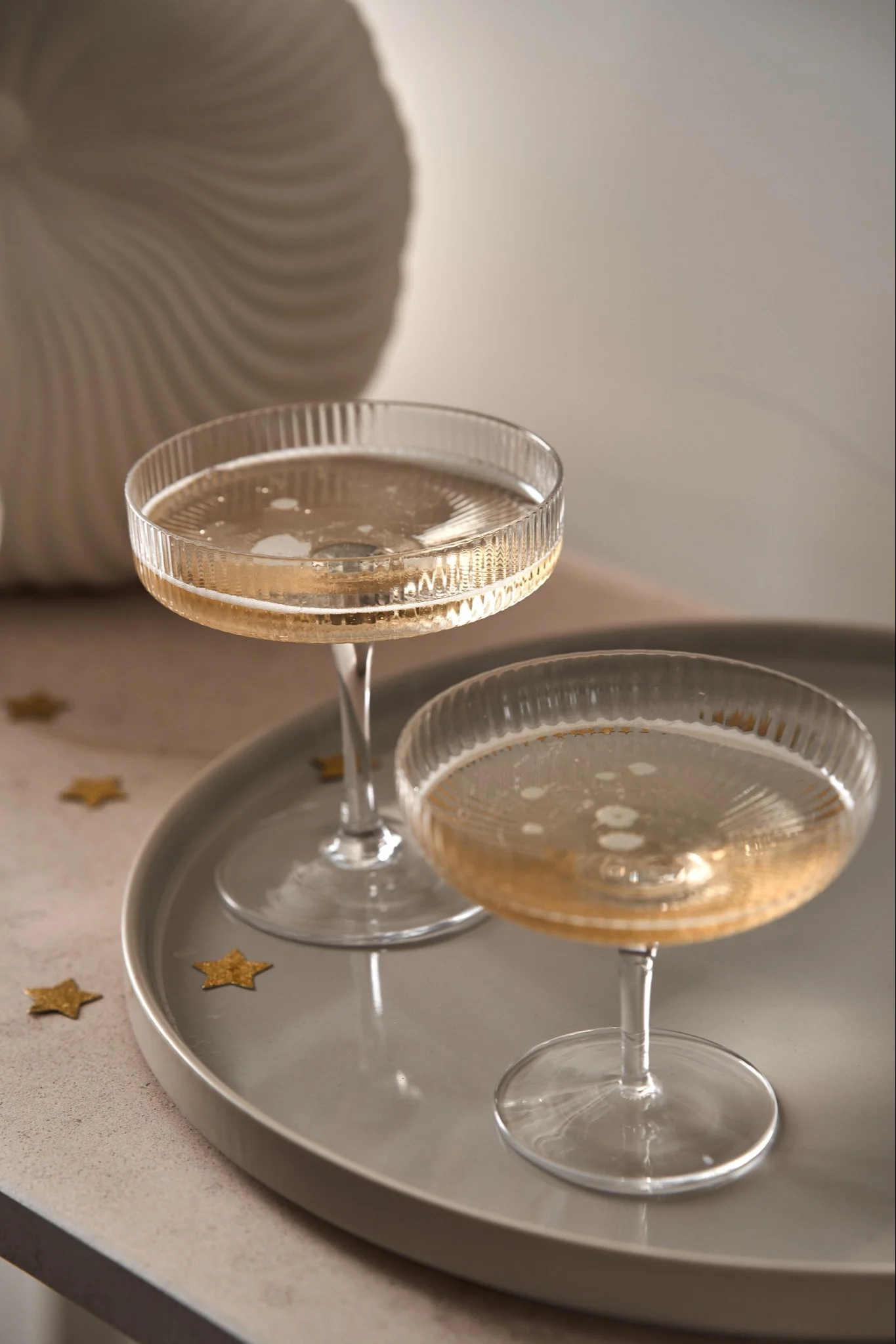 Coupe glasses ready to be placed in a champagne tower, here you see Ripple and Serax coupe glasses filled with champagne.