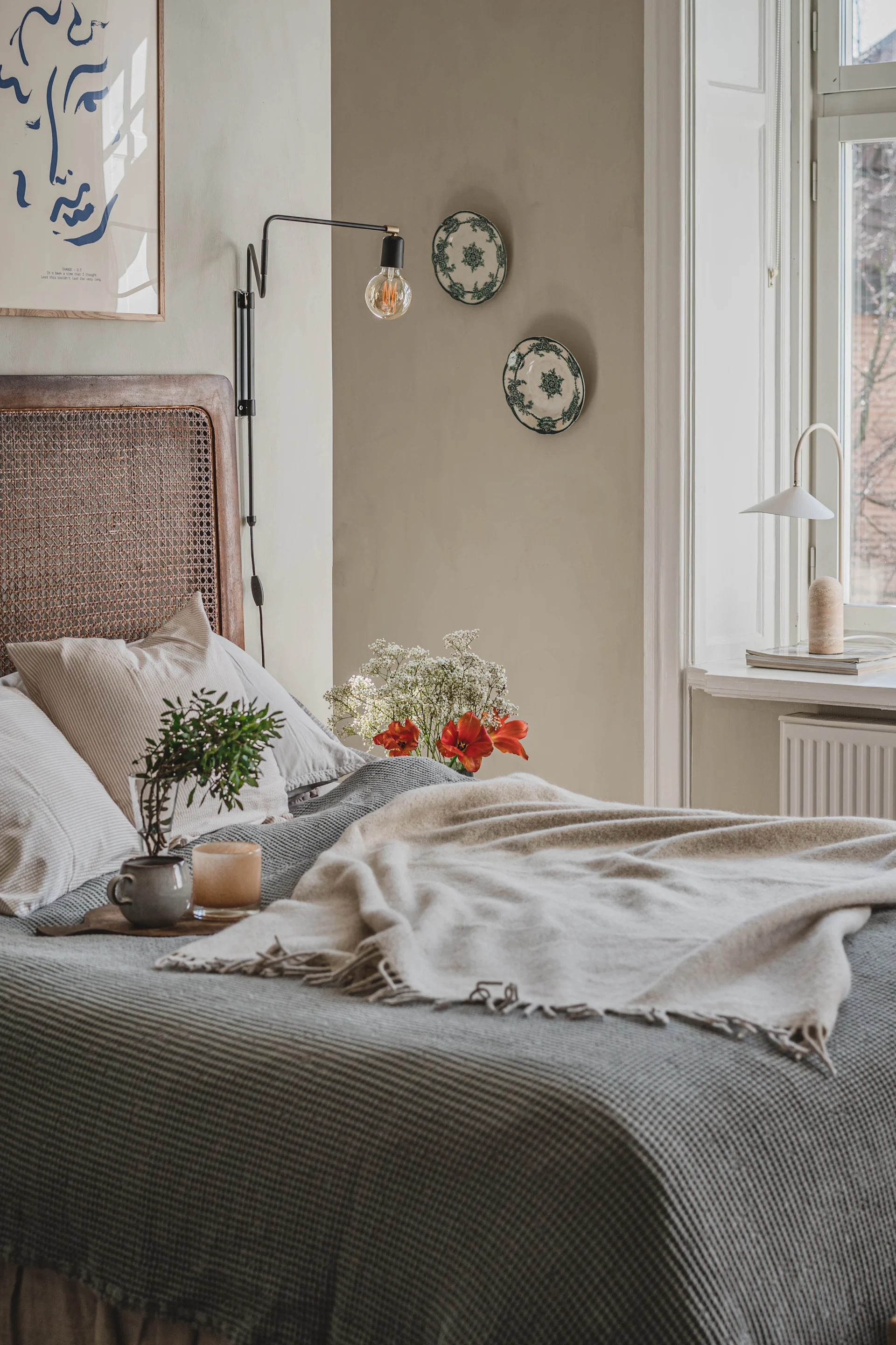 Create a cosy bedroom with neutral colours, cosy bedding, and personal details like Hannes has done here.