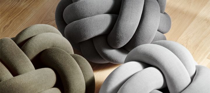 A collection of XL Knot Cushions in light and dark grey and green - the perfect unique cushion to sit on. 