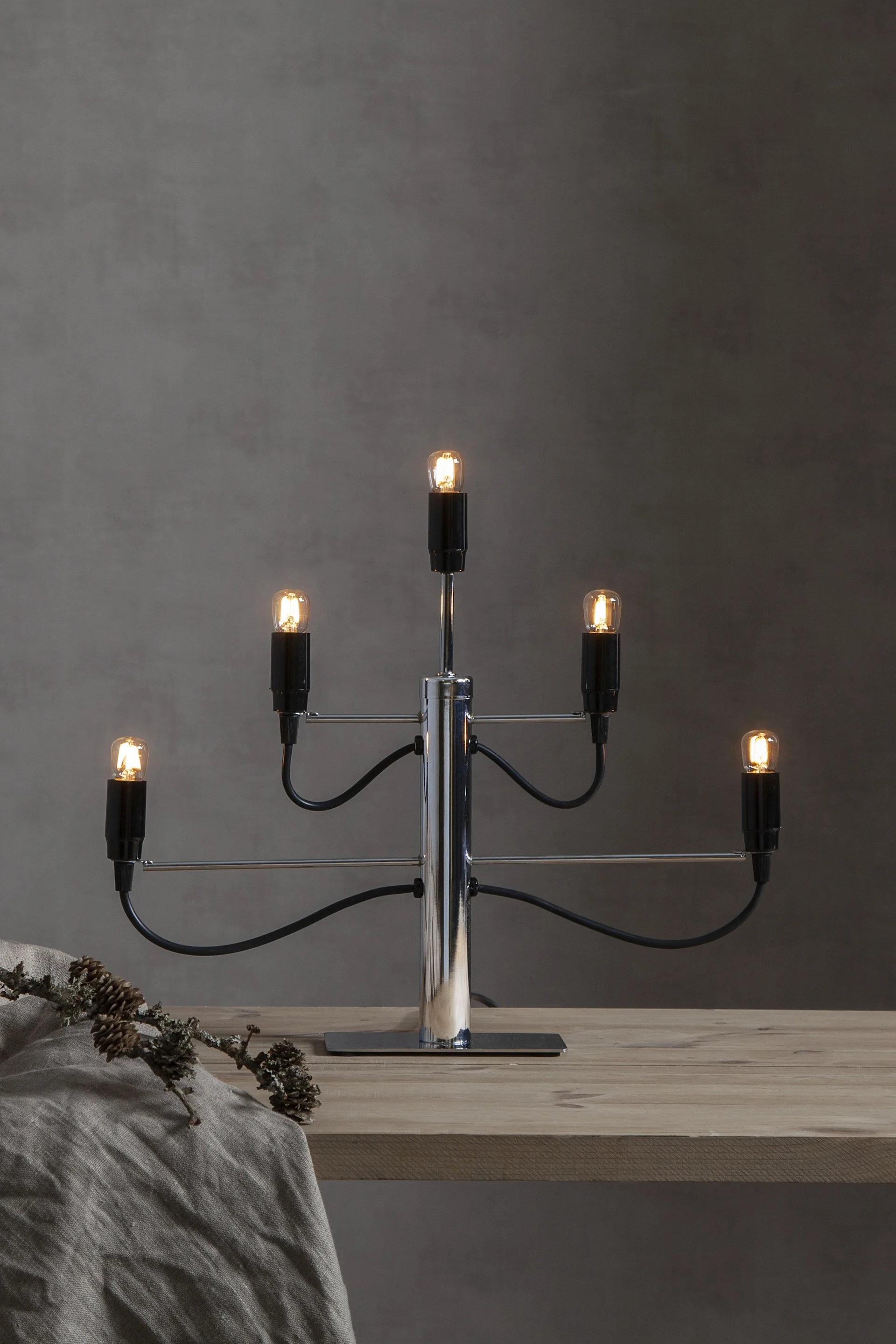 A sleek metal Advent candle holder with space for five candles