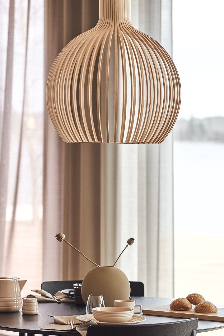 Octo ceiling lamp from Secto Design in beige hanging over the dining table - one of our 7 beige interior design favourites to invest in this autumn.