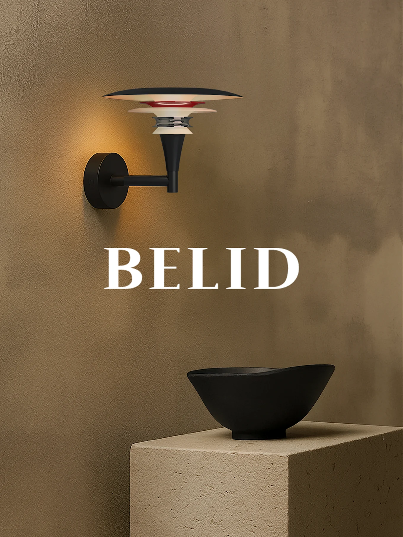 Wall lamp with layered shades illuminating a textured brown wall. A black bowl sits on a concrete block. 'BELID' text.