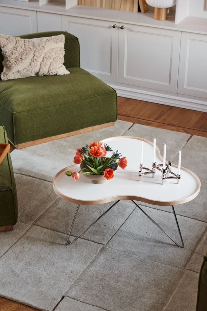 A bouquet of fresh tulips are placed on the flower coffee table from Swedese. 