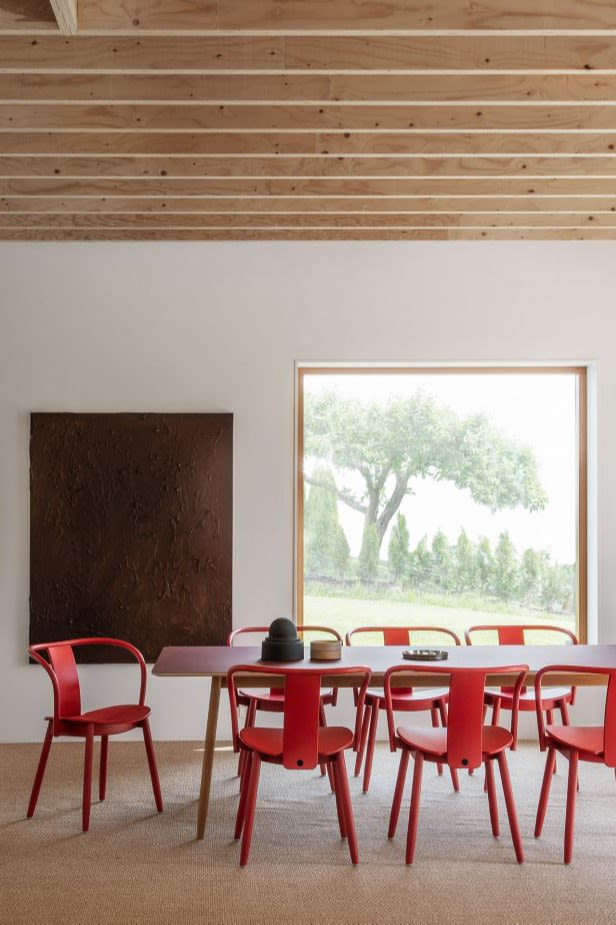 Red kitchen chairs from Massproductios show what the red trend could look like in the Scandinavian interior design trends 2024. 