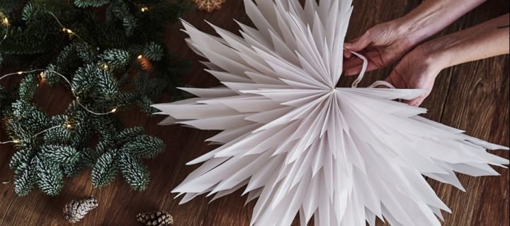 How to decorate with traditional Scandinavian Christmas decorations - Hanging paper Christmas stars like the Oslo paper star seen here are a very Scandinavian decoration at Christmas time. 
