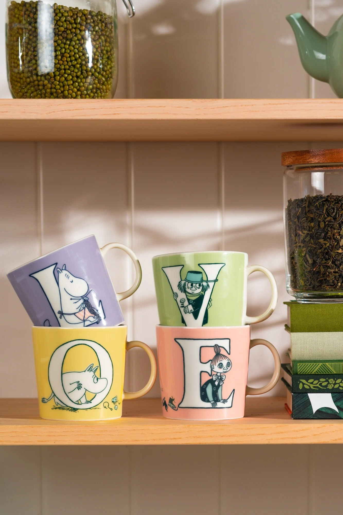 Four Moomin mugs from the ABC collection stand on a sideboard and form the word ‘Love’.