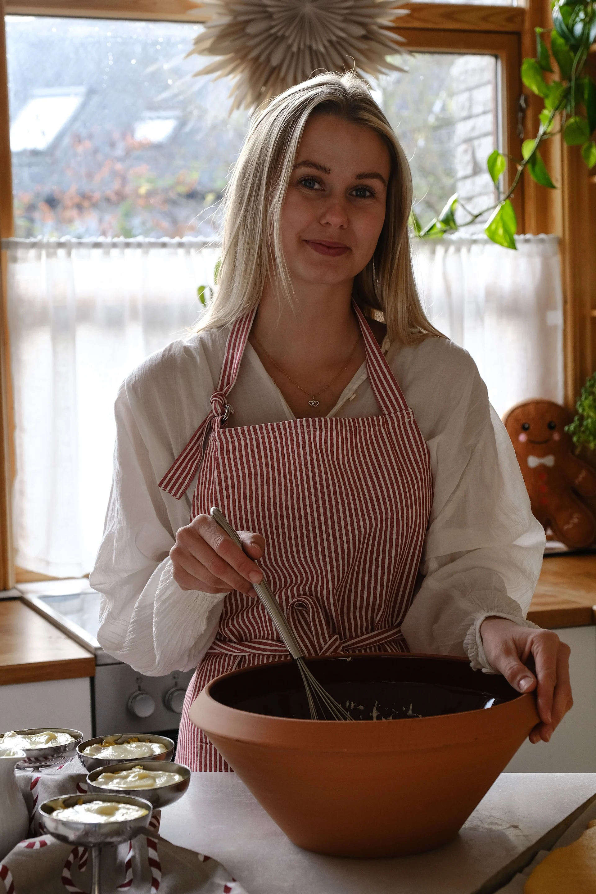 Frida stands working with a large bowl, mixing together a saffron-scented dough for a princess cake.