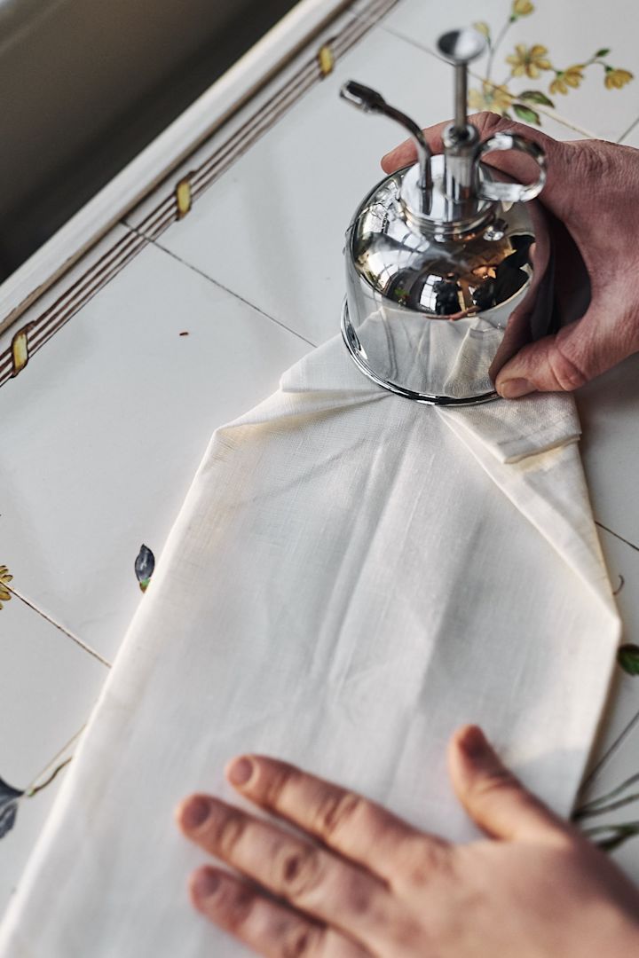 Napkin folding ideas - step 5 in folding a stylish shirt. 